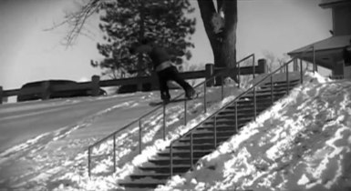 rail slide snowboarder